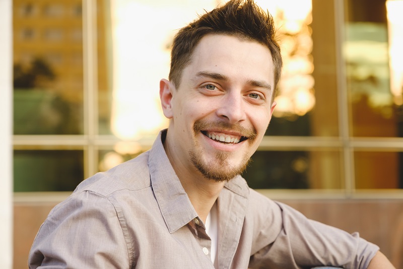 Handsome man outdoors portrait in the city. Warm colors